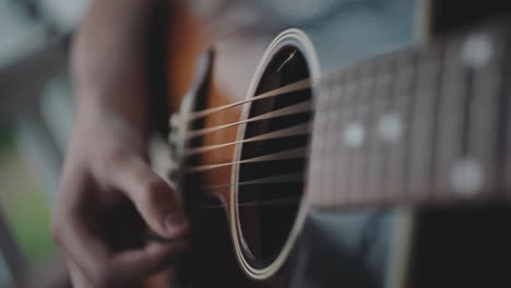 close-up of a person playing an acoustic guitar.