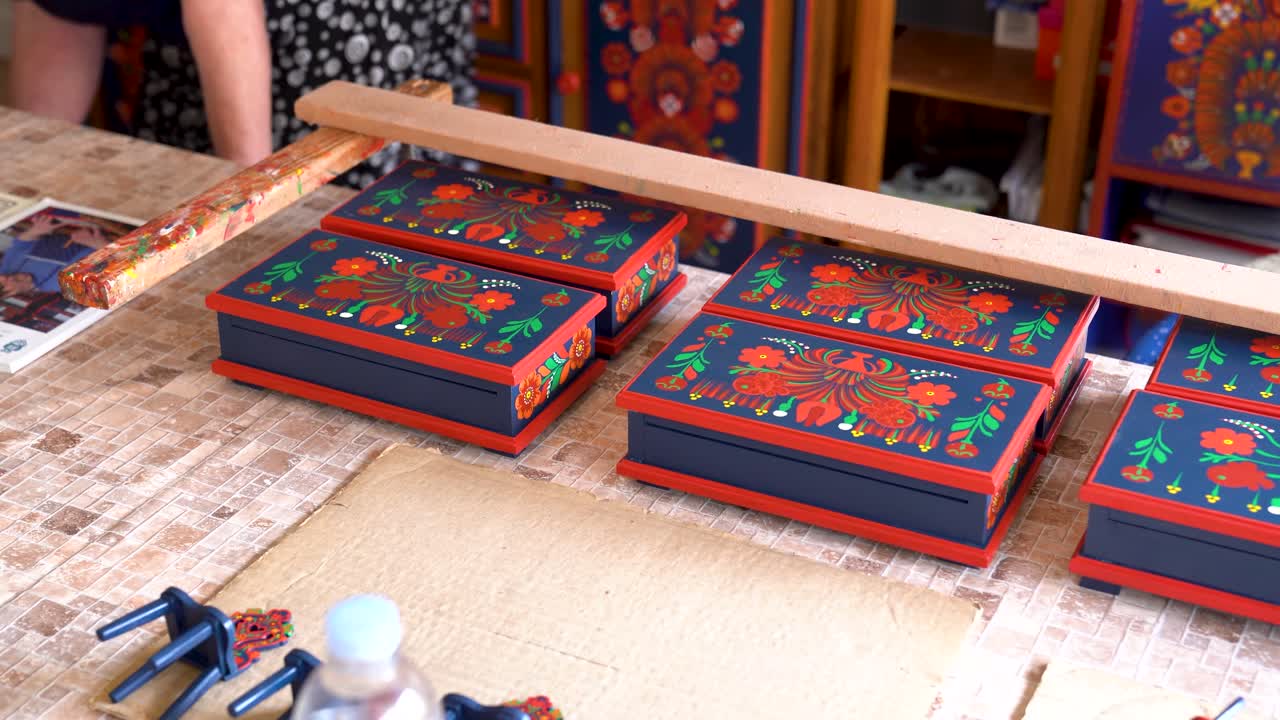 Row of Matyó hand-painted boxes drying in workshop after detailed decoration