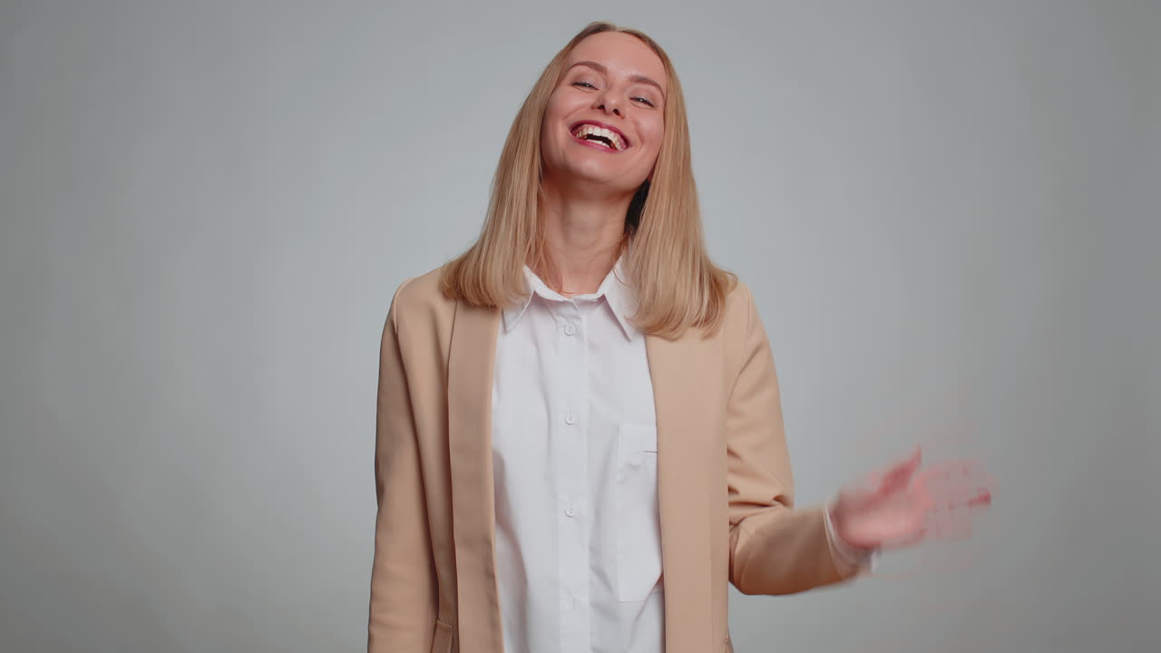 Woman showing inviting gesture with hands ask to join beckoning to coming gesturing hello goodbye