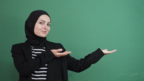 muslim woman pointing right