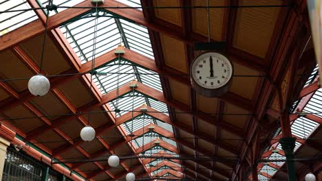 clock hang from ceiling at masaryk railway station interior at noon, prague