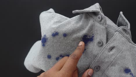 grey shirt with blue ink stains