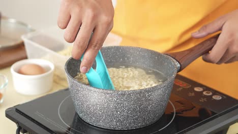 cooking instant noodles in a pot on an induction cooktop