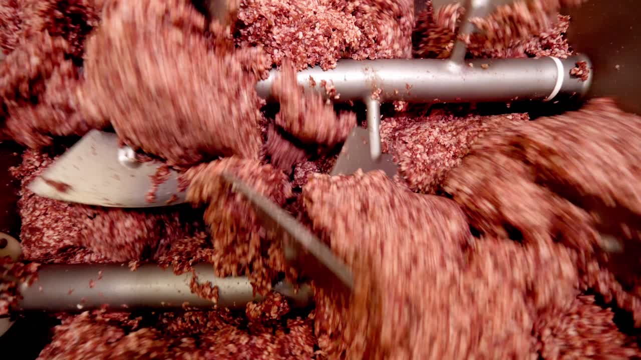 Meat being ground in a machine
