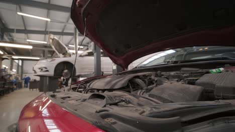 computer diagnostics of cars, repairing vehicle with open hood at service station