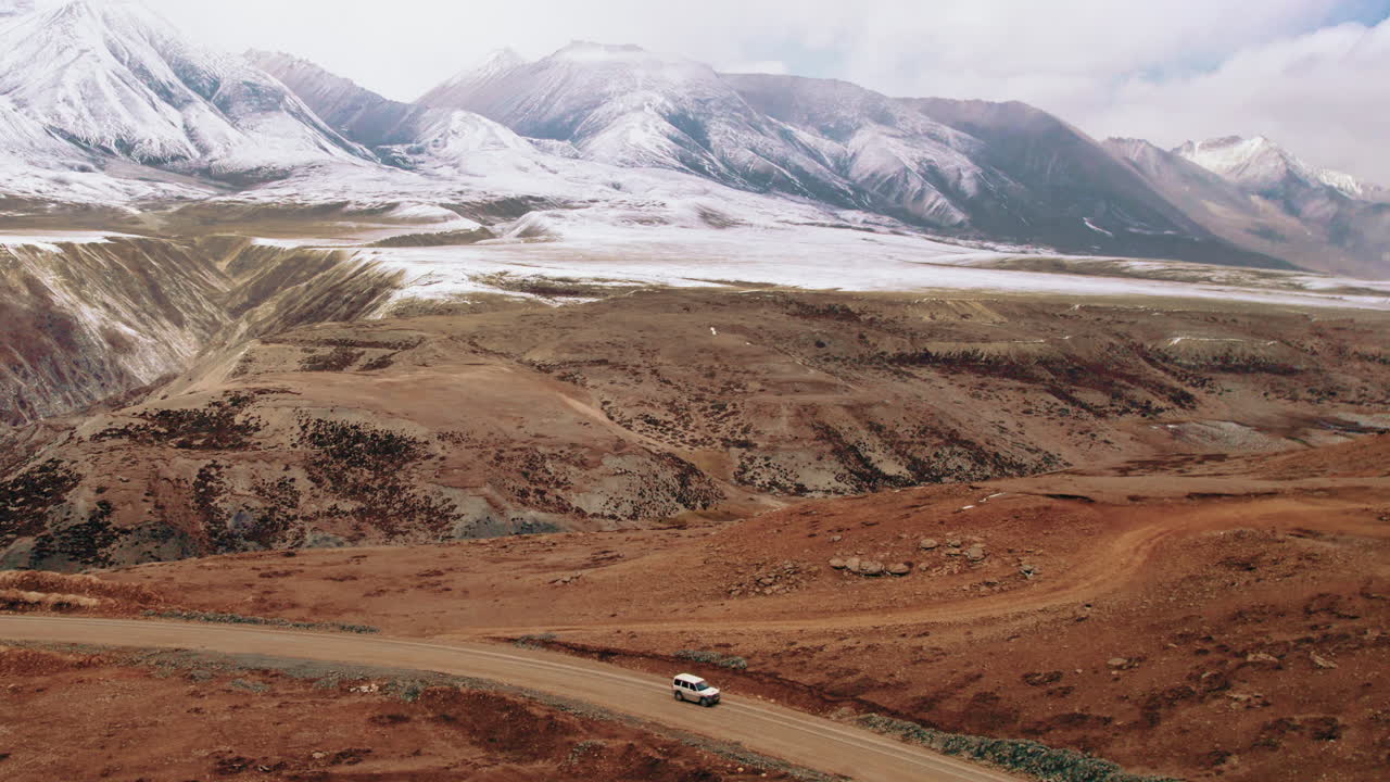Thrilling drone shot: Jeep speeds through desert road of Korala Border at  Lomanthang, Upper Mustang, Nepal. Majestic mountain ranges and open plains ignite wanderlust. Perfect for adventure-seekers.