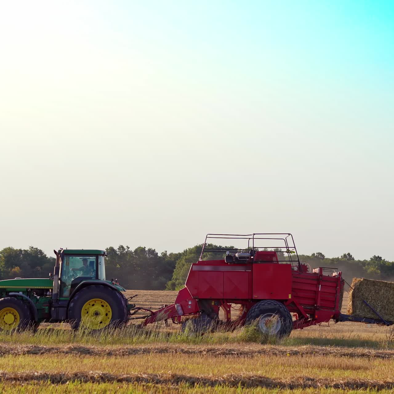 Haymaking tractor on field