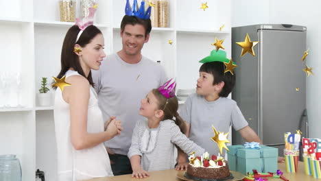 family celebrating birthday with cake and presents, star animation over scene