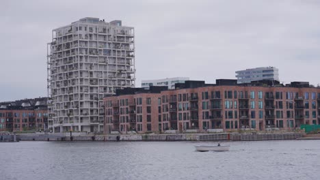massive residential building block near city canal in copenhagen, denmark