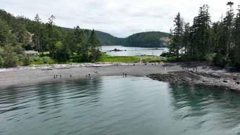 Drone-shot-flying-towards-people-playing-on-the-beach-in-Washington-State