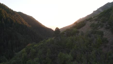 wasatch mountain ridge aerial flyover in utah's millcreek canyon at sunset