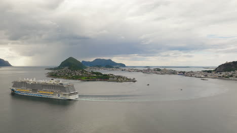 high angle side view of cruise ship departing alesund on geirangerfjord, norway