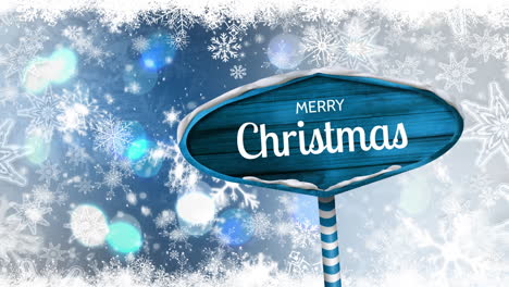 merry christmas written on wooden sign board with snow falling