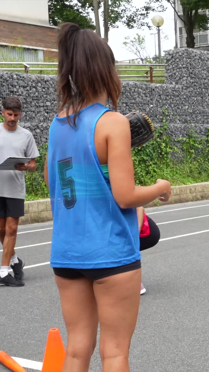 People playing softball outdoors