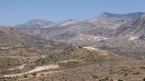 Aerial-view-passing-across-the-Turkish-Taurus-mountains-and-scenic-rural-valley-terrain