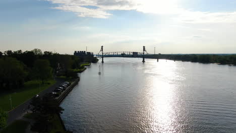 pan over delaware river and bridge during sunset