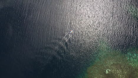 topdown drone shot of a boat driving through the ocean in palawan, philippines, asia, cinematic, aerial