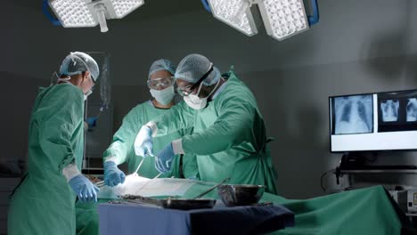 diverse surgeons with face masks during surgery in operating room in slow motion