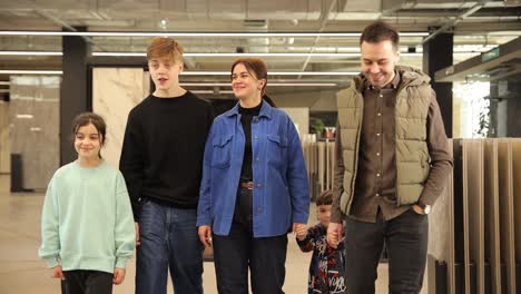 a large friendly family with three children in a construction supermarket a large friendly family with three children in a construction supermarket on a background of ceramic tiles happy family shopping for home