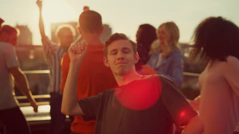 Energetic-guy-dancing-at-urban-party.-Multiracial-people-partying-outdoors.