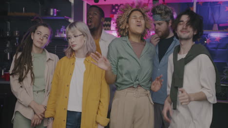 group of friends partying in a kitchen