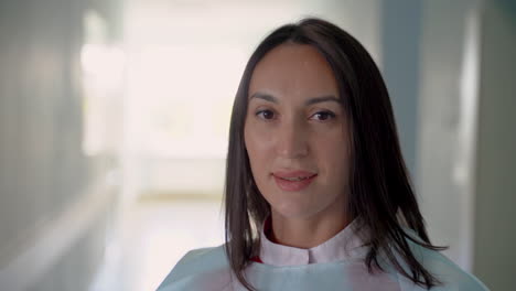 female confident doctor smiles looking at camera