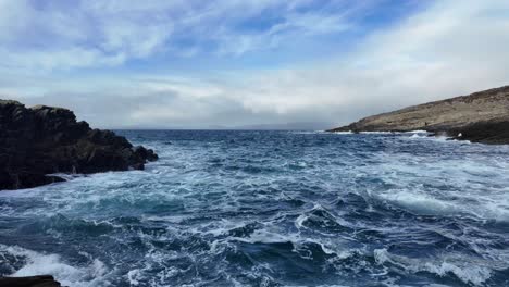 irish coast dramatic waves moody sky and churning waves crashing on beach west cork in winter