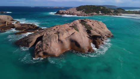 drone floating above jumping rock in twighlight beach, esperance western australia