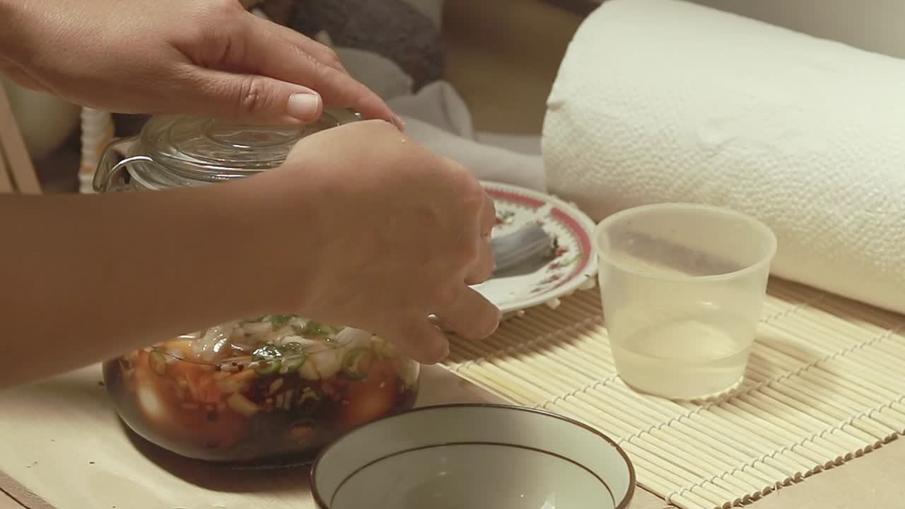 Sealing a mason jar containing a newly made mayak gyeran or korean marinated eggs, authentic traditional local dish of Korea