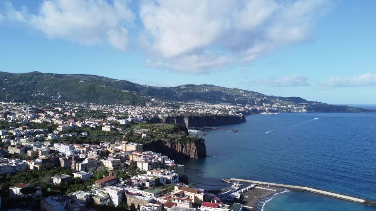 Coastal view of Sorrento with harbor and hills. Drone video of Sorrento cliffside coast