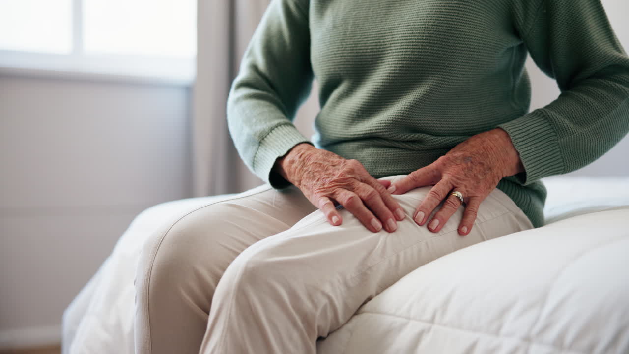 Senior woman sitting on bed at home
