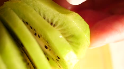 sliced kiwi with fingers