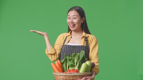 woman holding a basket of vegetables