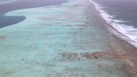 Epic-aerial-panoramic-overview-of-kite-surfers-sailing-on-inside-of-barrier-reef