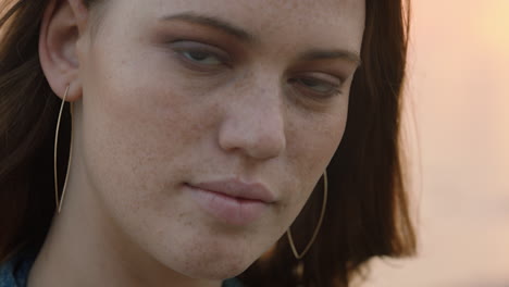 close up portrait of beautiful young woman looking confident enjoying seaside at sunset