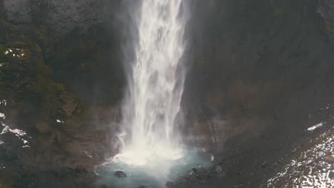 Close-up-shot-of-a-waterfall-plunge-pool-in-Iceland-with-nesting-birds-flying-around