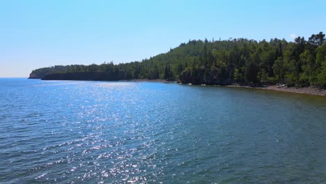 lake superior waters and minnesota forest on a sunny summer day