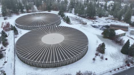 orbiting aerial view of two large reservoir structures during the spokane winter