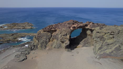 Fuerteventura-Island:-aerial-view-in-orbit-over-the-Jurado-arch-on-a-sunny-day-with-beautiful-colors