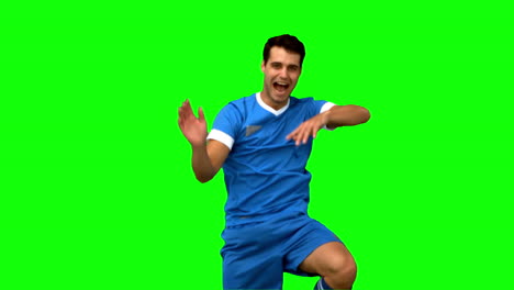 Football-player-celebrating-a-goal-on-green-screen