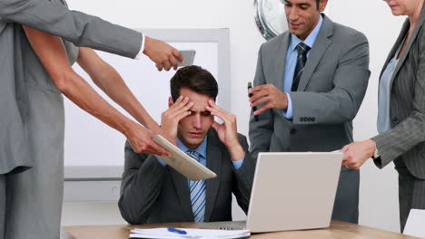 anxious businessman sitting with hands on head