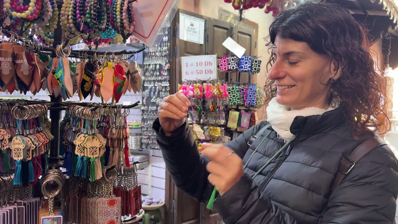 Happy Woman Shopping for Souvenirs at a Local Market Stall