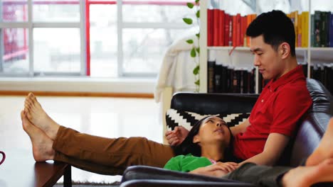 Couple-relaxing-on-sofa-in-living-room