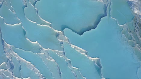 white travertine terraces or travertine pools that cascade down the hillside in pamukkale