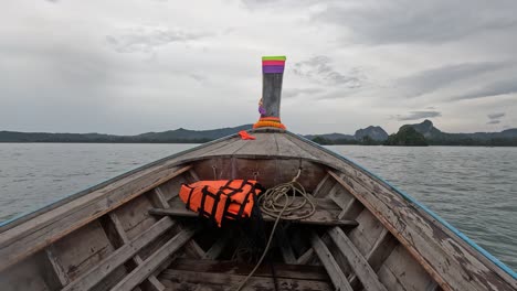 wooden longtail boat on the water