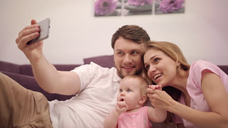 selfie photo in family home. man taking photo with happy family