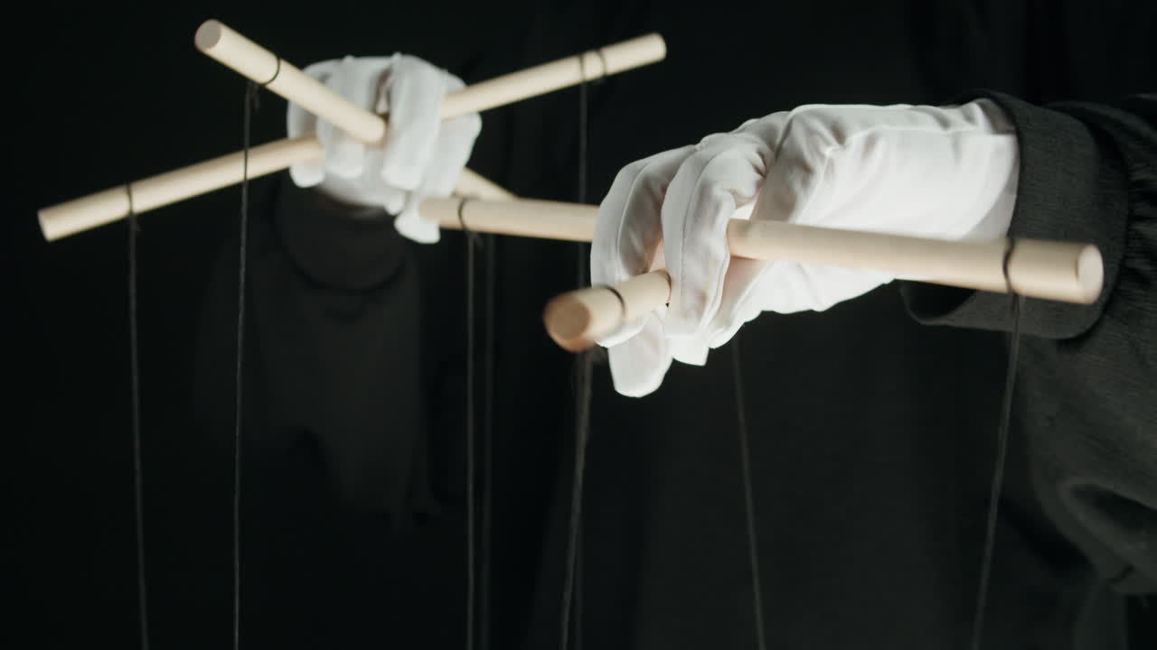 Hands in White Gloves Operating Puppet Control Bar