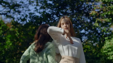 two women posing outdoors in park