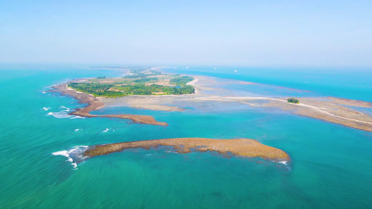 Aerial view of tropical coral island over the blue sea. Drone forward tracking shot. Saint martin Island, Bangladesh