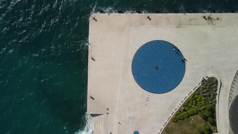 minimal people and geometrical shapes by the sea
